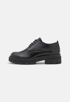 Black leather shoes with a textured crocodile pattern, rounded toe, lace-up design, and thick rubber sole.