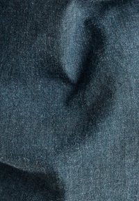Tejido azul oscuro con una superficie suave y texturizada, que presenta sutiles variaciones en el tono y una apariencia ligeramente arrugada.