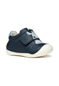 Scarpa da bambino in pelle blu con design blu navy, suola in gomma bianca, straps in velcro e grafica di un volto di animale sulla parte anteriore.