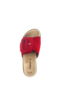 Red suede slide sandal featuring a wide strap with a rectangular buckle, a cushioned beige insole, and a rounded toe design.