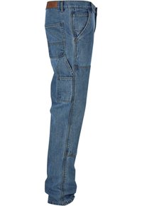 Blue denim cargo pants with multiple pockets, a straight leg design, and a brown leather waistband accent. Textured fabric with visible stitching.