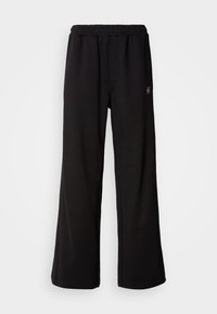 BADGE LOGO - Tracksuit bottoms - black
