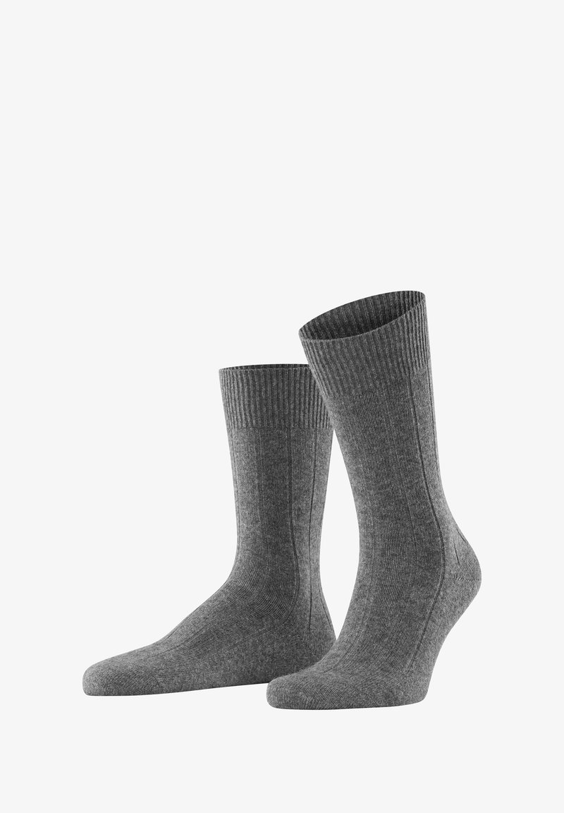 Graue gerippte Socken mit glatter Textur, knöchelhohem Design und verstärktem Zehenbereich. Besitzen ein dezentes Muster an der Seite für zusätzliche Details.