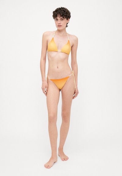 Yellow bikini set featuring a triangular top with thin straps and a low-rise bottom with tie sides, smooth texture, and ombre color gradient.