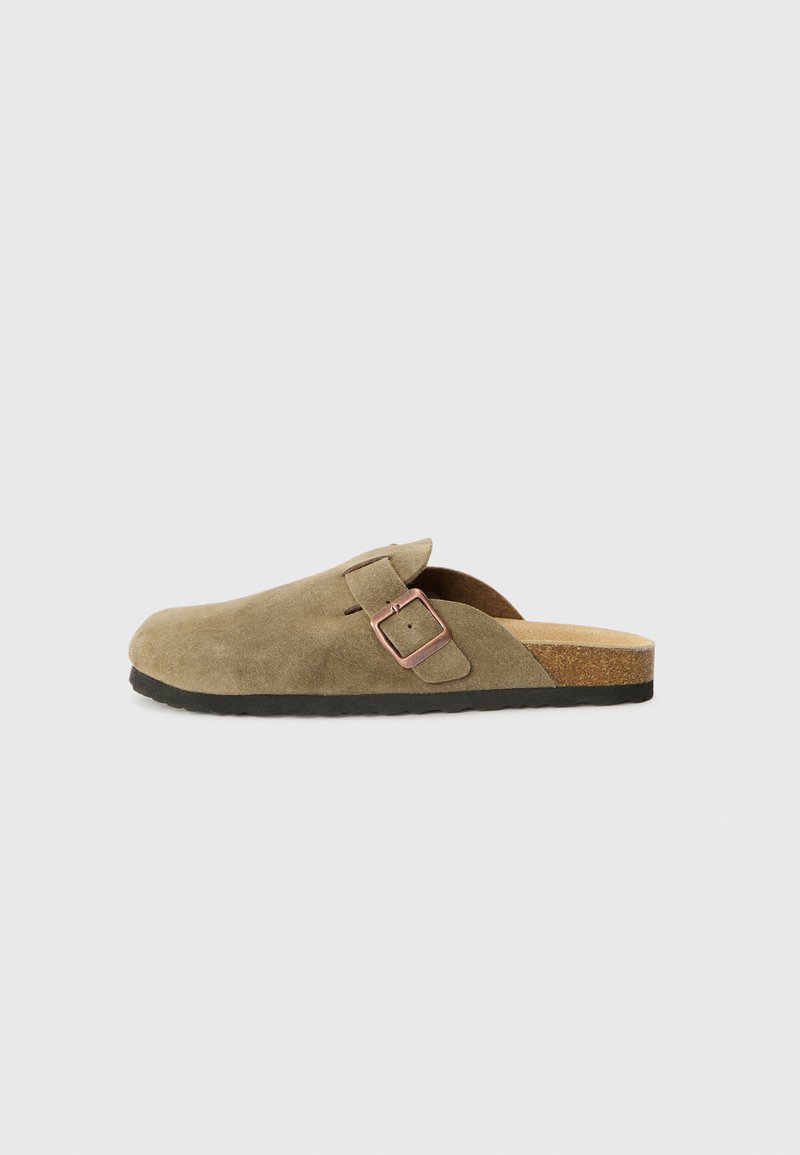 Brown suede mule slip-on shoe with a single side buckle, cork footbed, and black rubber sole. Smooth texture and rounded toe.