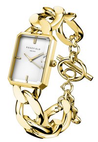 Montre rectangulaire en or avec un cadran blanc épuré, trois aiguilles, bracelet à maillons larges et fermoir à bascule, présentant une surface texturée.