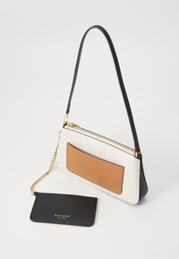 White leather handbag with a tan leather accent, black strap, and gold hardware. Includes a matching black cardholder with logo.
