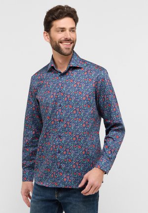 Chemise à manches longues pour homme en bleu marine avec un motif floral. Dotée d'une fermeture à boutons, d'un col et d'un tissu texturé. Convient pour un usage décontracté.