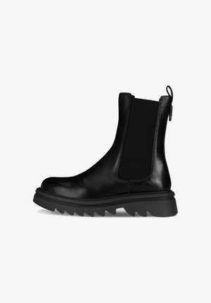 Bota de tobillo de cuero negro con paneles laterales elásticos, punta redonda y suela de goma con estrías. Lengüeta trasera para facilitar su uso. Textura suave.