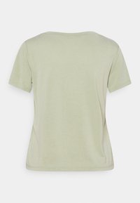 T-shirt uni vert clair à manches courtes avec col rond, montré de dos sur fond blanc.