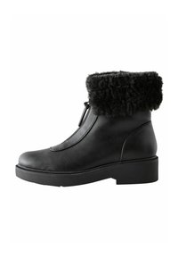 Black leather ankle boot featuring a textured faux fur cuff, a smooth finish, rounded toe, and a chunky sole for stability.