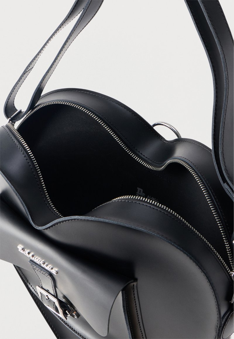 Black leather handbag with curved zipper opening, front flap pocket with buckle, and adjustable shoulder strap.