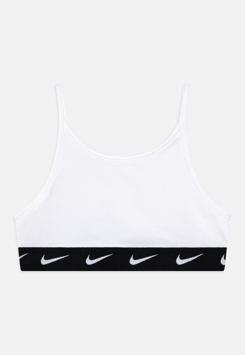Valge spordibrasi, mis on valmistatud venivast kangast, millel on õhukesed õlapaelad ja must riba, millel on allpool valged Nike logo'd.