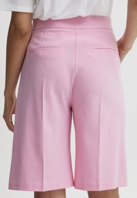 Roze op maat gemaakte shorts met een rechte snit, voorzien van een gladde textuur, twee achterzakken en een middelhoge tailleband.
