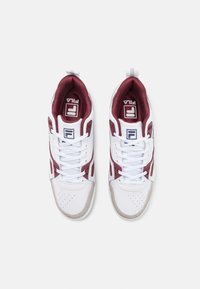 Sneaker sportive bianche e borgogna con tomaia in mesh e sintetico, dotate di lacci bianchi, perforazioni sulla punta e suola in gomma grigia.