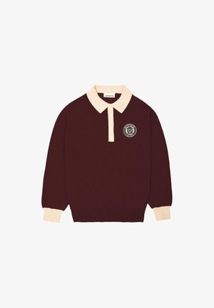 Maroon long-sleeve polo shirt with cream collar and cuffs, buttoned placket, and circular "Prohibited Berlin" logo on the left chest.