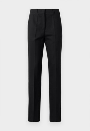 Pantalons noirs ajustés, en tissu lisse, avec une coupe droite, des plis pressés et des fentes latérales au niveau de l'ourlet.
