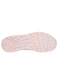 Light pink athletic shoe sole with a textured grip pattern featuring various geometric shapes and angled grooves for traction.