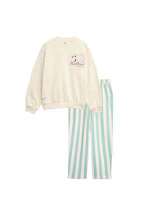 Sweat-shirt crème avec le texte « Peace, Love and Mallows » et un design cartoon, associé à un pantalon rayé vertical bleu clair et blanc.