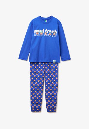Camiseta azul de manga larga para niños con texto Paul Frank y caras de mono, combinada con pantalones azules a juego cubiertos con coloridos patrones de caras de mono.