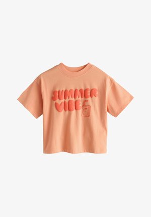 Kortærmet T-shirt i ferskenfarve med "SUMMER VIBE" i fede, puffede bogstaver og en lille juiceboks grafik foran.