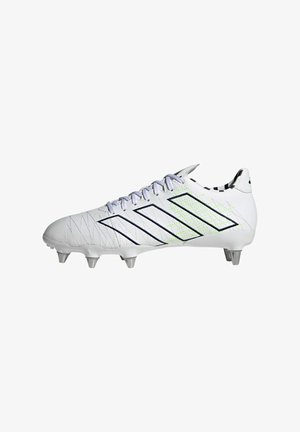 Botines de fútbol blancos con acentos multicolores, presentan una parte superior texturizada, cinco tachuelas metálicas y un diseño con cordones. Detalles en negro y verde neón.