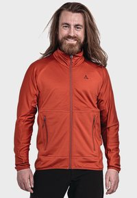 Rote Fleecejacke aus strukturiertem Material, hoher Kragen, Reißverschlusstaschen vorne und kontrastierendem Reißverschluss. Slim-Fit mit modernem Design.