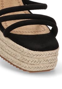 Sandal black de ante con plataforma y detalles de cuerda trenzada, que cuenta con tres correas negras y una plantilla beige texturizada.
