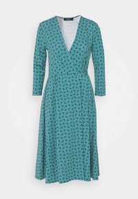 Robe portefeuille bleu sarcelle avec un col en V, des manches longues et une taille cintrée. Ornée de motifs tourbillonnants bleus, en tissu lisse, jupe longueur genou.