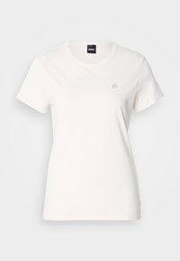 Biała bawełniana koszulka z okrągłym dekoltem i krótkimi rękawami. Na piersi znajduje się małe haftowane logo. Gładka tekstura.