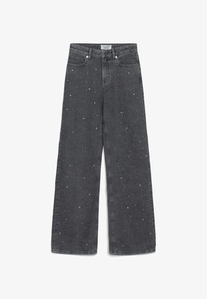 Jeans neri a gamba larga con vita alta e piccole macchie bianche sparse, con tasche frontali e passanti per cintura.