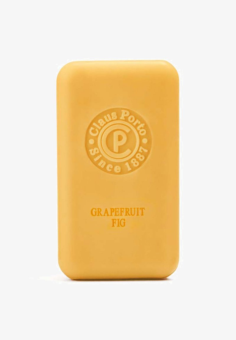 Gelbe rechteckige Seife mit abgerundeten Kanten, geprägt mit einem Logo und dem Text "Grapefruit Feige". Glatte Textur und solides Design.