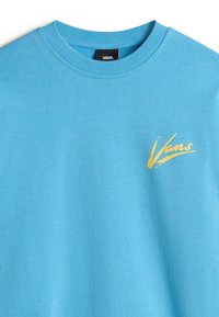 Light blue cotton t-shirt featuring a crew neckline and a yellow Vans logo on the front, showcasing a smooth texture and casual design.