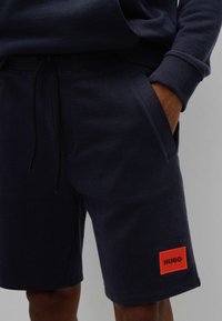 HUGO DIZ - Tracksuit bottoms - dark blue