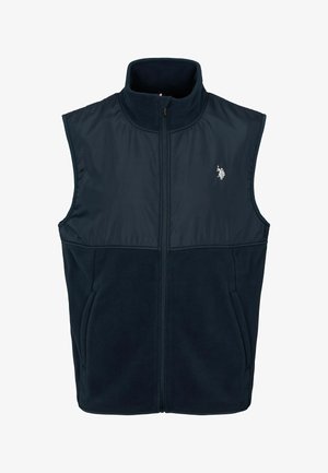 Námornícke modrá fleecová vesta s vysokým golierom, plným zipsom a spodnými vreckami na ruky. Obsahuje kontrastnú textilnú panel na hrudi.