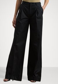 Black wide-leg trousers made of smooth fabric, featuring front pleats, a button closure, and a clean hemline.