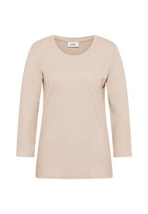 Camiseta de manga larga beige hecha de algodón suave. Tiene un cuello redondo, un corte relajado y cuenta con una etiqueta en el cuello.
