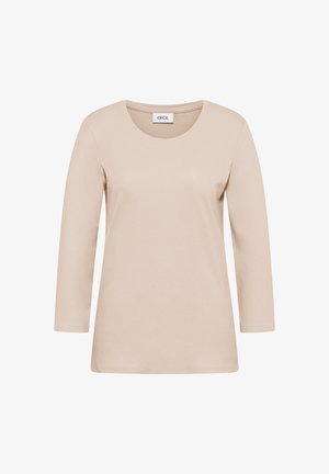 Beżowa koszulka z długim rękawem wykonana z miękkiej bawełny. Ma okrągły dekolt, luźny krój i zawiera metkę przy dekolcie.