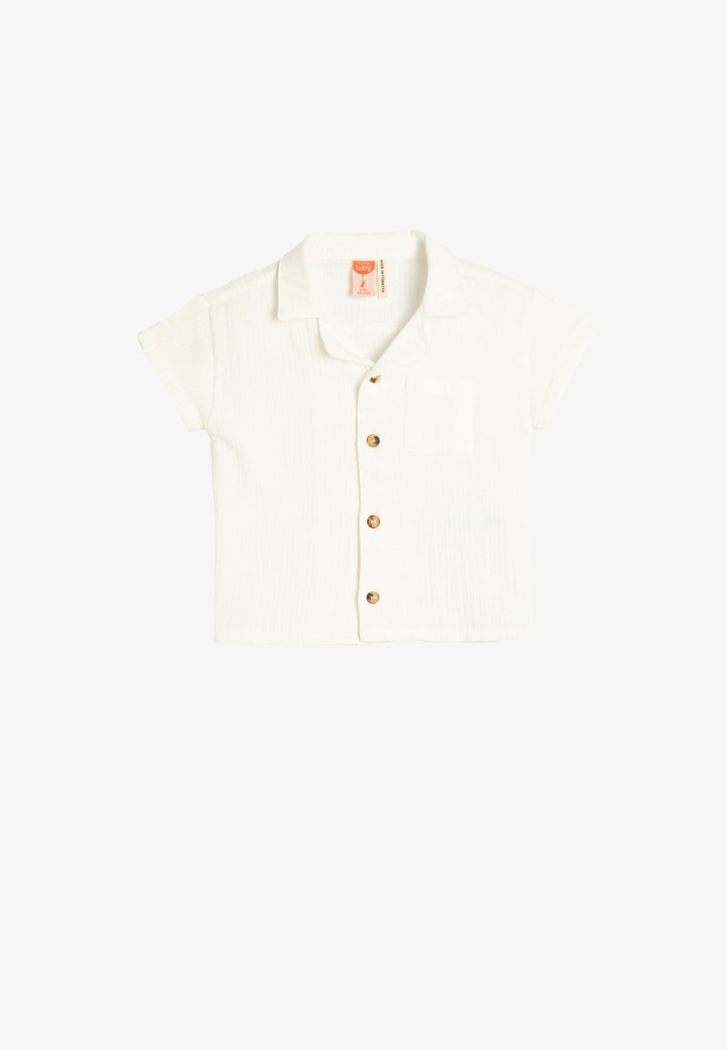 Kortærmet, kravebåden hvid skjorte lavet af tekstureret stof, med knaplukning foran og en enkelt lomme på venstre bryst.