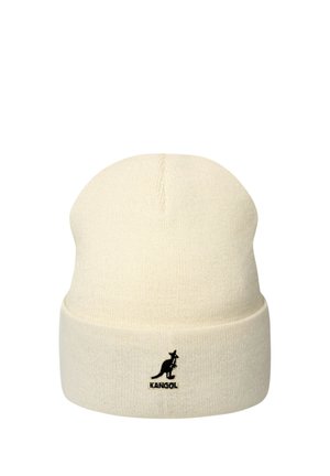 Gorro de punto color crema con un doblez en la parte inferior, con un pequeño logo negro de canguro y la palabra "KANGOL" en la parte delantera.