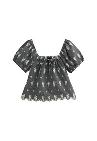 Black and white checkered blouse with short puff sleeves, a scalloped hem, and floral pattern accents. Drawstring neckline for adjustable fit.