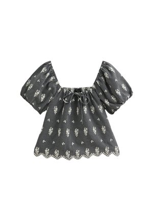 Black and white checkered blouse with short puff sleeves, a scalloped hem, and floral pattern accents. Drawstring neckline for adjustable fit.