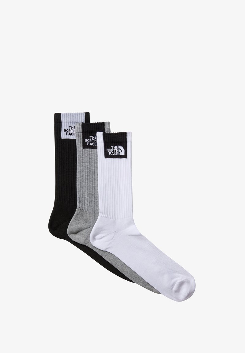 Trzy pary ryflowanych skarpetek typu crew w kolorze czarnym, szarym i białym, z logo The North Face na górze.