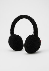 Casque audio noir et fluffy avec un bandeau épais et texturé et des coussinets doux. Présente une petite étiquette rouge d'un côté.