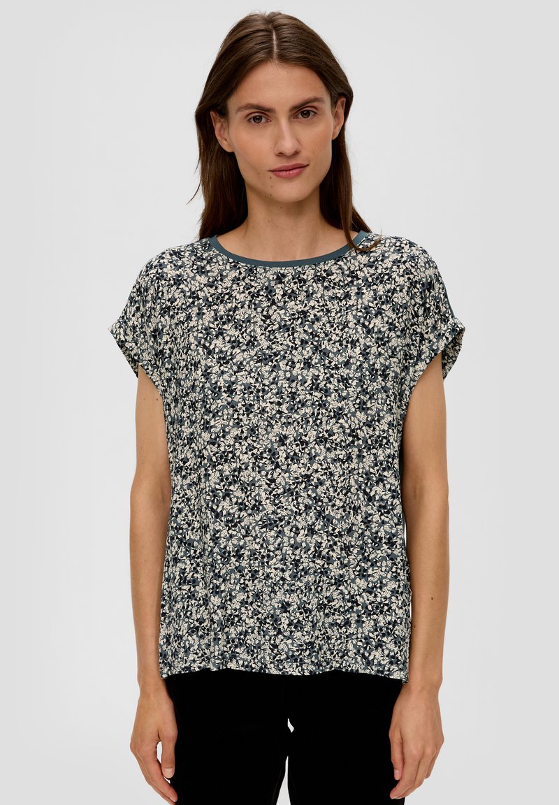 Bluse mit Floralprint und kurzen Ärmeln. Weicher Stoff, runder Ausschnitt, dunkelblaue Basis und helle cremefarbene, beige und marineblaue Muster.