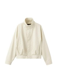 Veste couleur crème avec petits pois noirs, col montant, manches longues, fermeture éclair à l'avant et deux poches latérales.