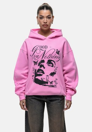 Roze oversized hoodie met een grafisch ontwerp van een vrouwenhoofd, vlinders en bloemenelementen in het zwart afgedrukt.