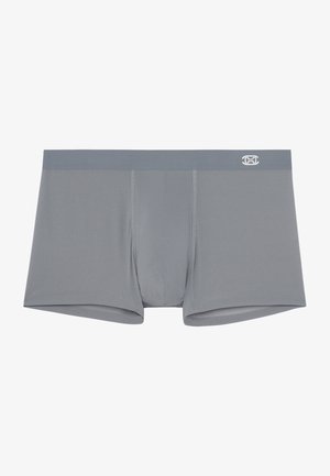 Boxers grises hechos de una tela suave. Presentan una cinturilla en contraste con el logo. Diseñados con un ajuste ceñido y costuras planas.