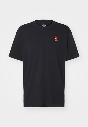 T-shirt noir à col rond en coton, avec un petit logo Nike multicolore en design rectangulaire sur la poitrine. Manches courtes.