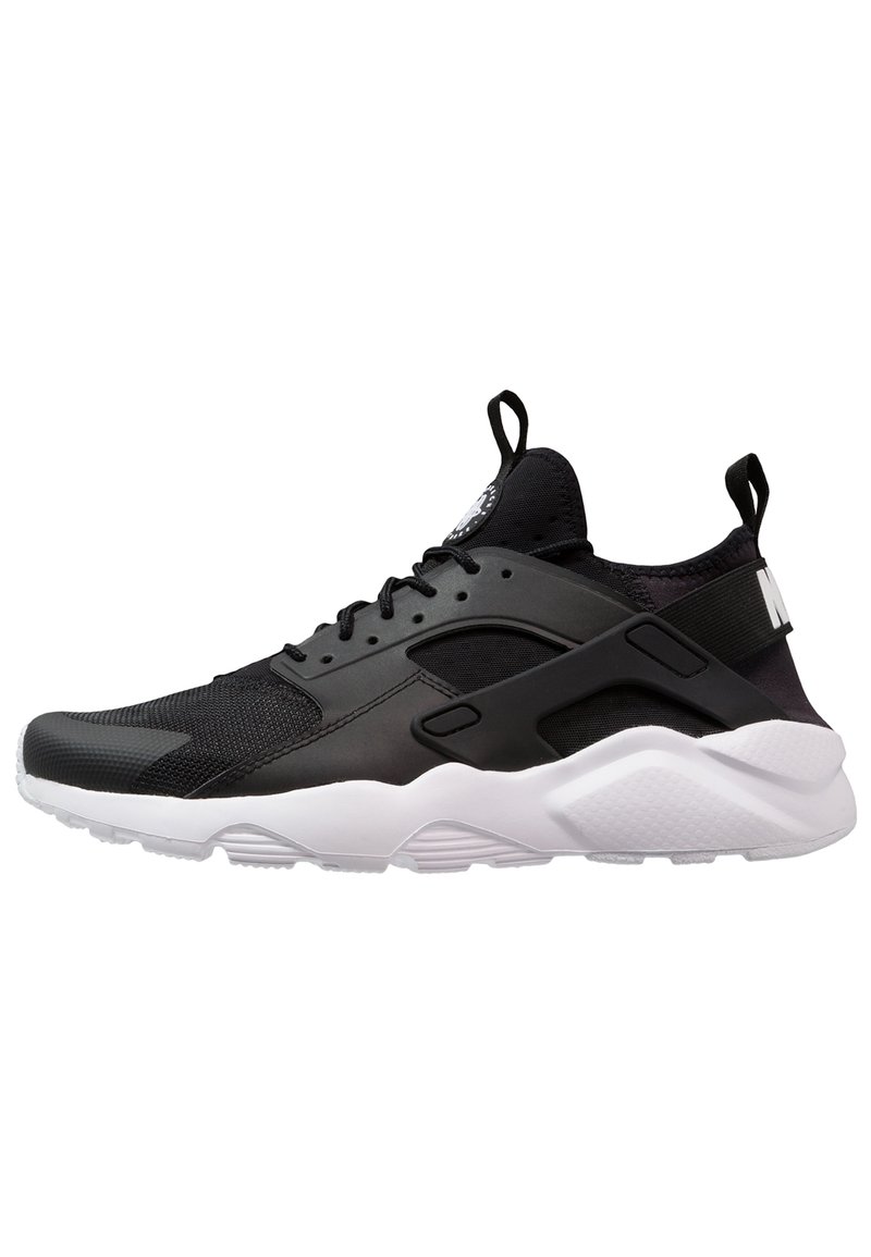 Black athletic shoe with mesh and synthetic materials, white midsole, distinctive heel cutout, and black accent details.